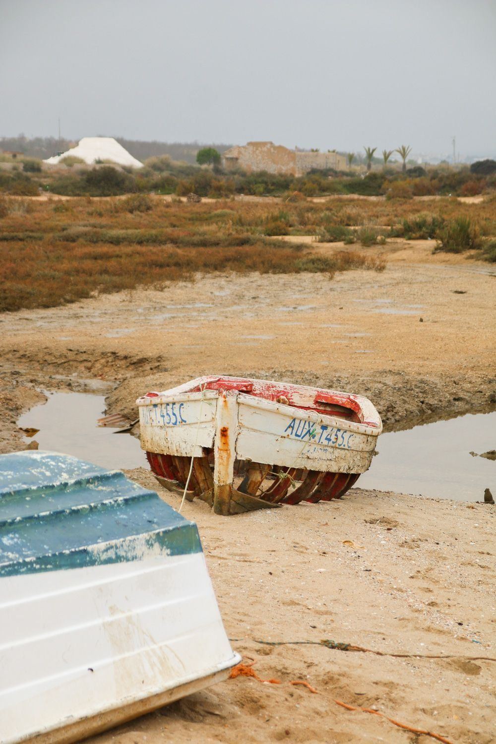 Weathered fishing boats on the tidal flats of the Ria Formosa