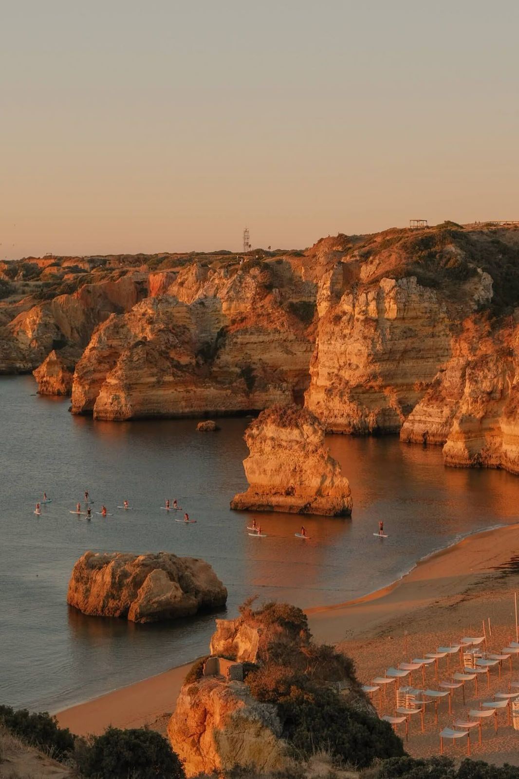 Golden cliffs and a sheltered cove at sunset, Algarve