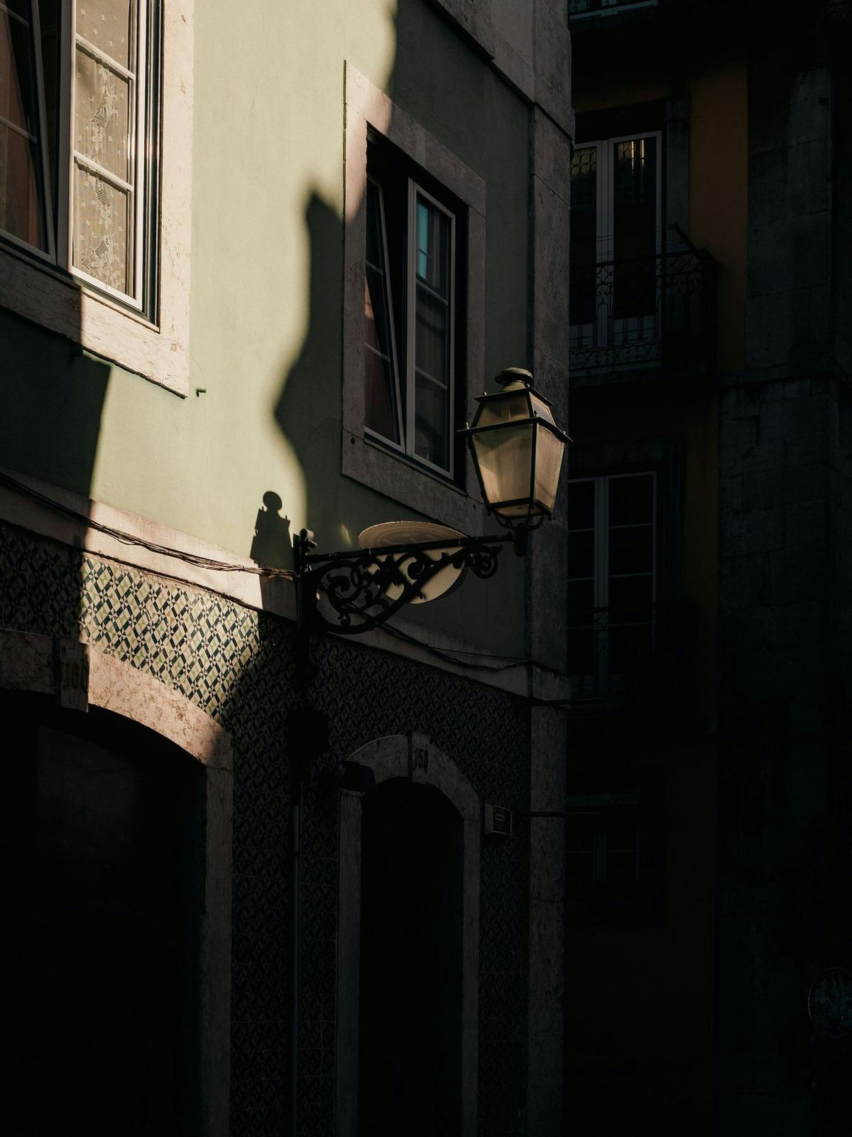 Evening light on a tiled facade and street lantern, Lisbon